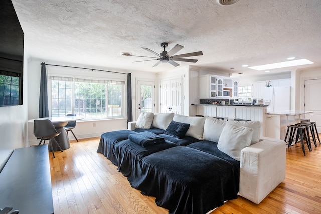 1703 Laurel Ave, Odessa, TX 79761 - living area with a textured ceiling, light wood-style floors, plenty of natural light, ceiling fan, and recessed lighting