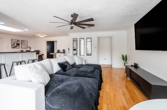 1703 Laurel Ave, Odessa, TX 79761 - living area with a ceiling fan, a skylight, light wood-style floors, a textured ceiling, and recessed lighting