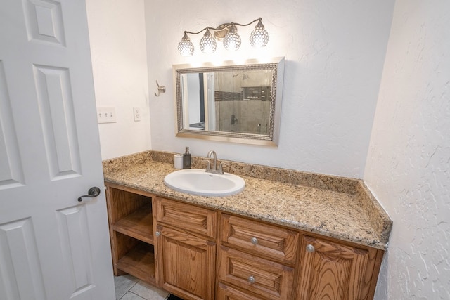 1703 Laurel Ave, Odessa, TX 79761 - bathroom featuring vanity, a tile shower, and tile patterned floors