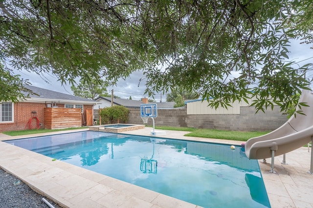 1703 Laurel Ave, Odessa, TX 79761 - view of pool with a water slide, a fenced backyard, and a pool with connected hot tub