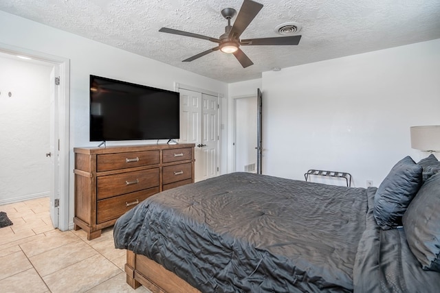 1703 Laurel Ave, Odessa, TX 79761 - bedroom with a textured ceiling, ceiling fan, and light tile patterned floors
