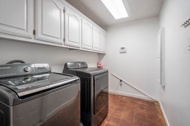 1703 Laurel Ave, Odessa, TX 79761 - laundry area featuring washing machine and clothes dryer, cabinet space, and dark flooring