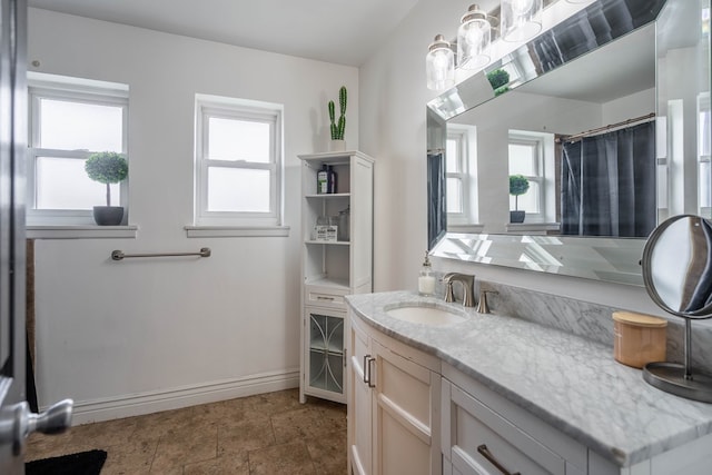 1703 Laurel Ave, Odessa, TX 79761 - full bath with healthy amount of natural light, vanity, and a shower with curtain