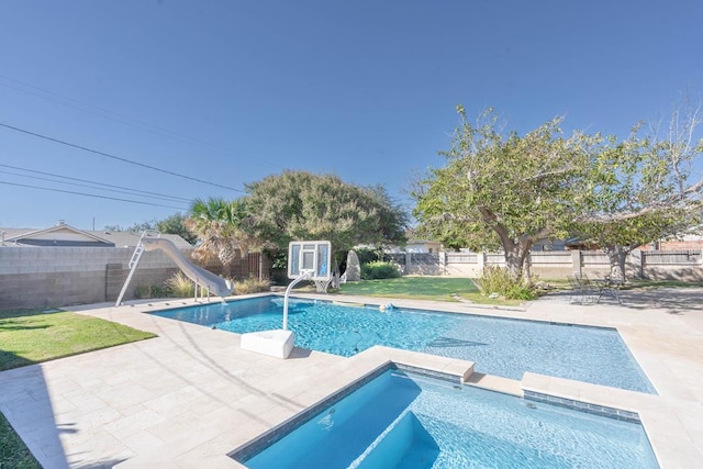 1703 Laurel Ave, Odessa, TX 79761 - view of pool featuring a water slide, an in-ground hot tub, a fenced backyard, and a patio area