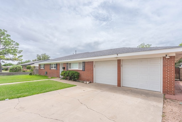 1703 Laurel Ave, Odessa, TX 79761 - ranch-style home with brick siding, driveway, a garage, and a front yard