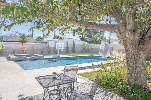 1703 Laurel Ave, Odessa, TX 79761 - view of pool with a water slide, a patio, a fenced backyard, and a pool with connected hot tub