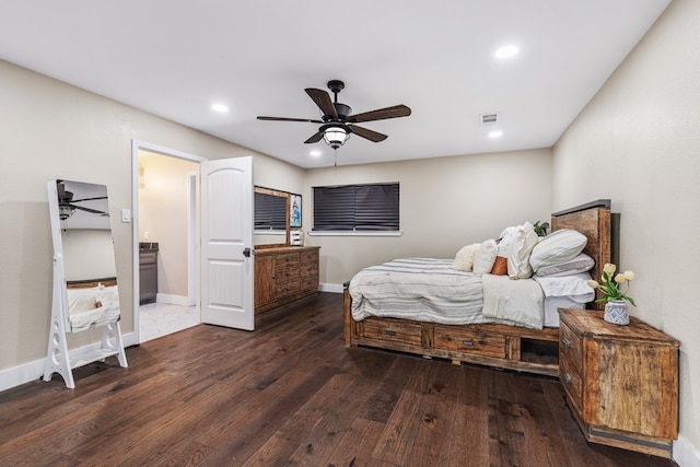 bedroom featuring dark hardwood / wood-style floors, ceiling fan, and ensuite bath