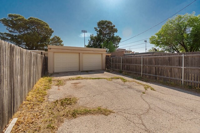 detached garage featuring fence