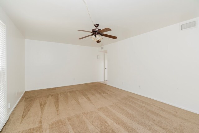 unfurnished room featuring visible vents, baseboards, a ceiling fan, and carpet flooring