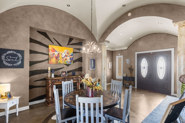 dining room featuring an inviting chandelier, lofted ceiling, and decorative columns