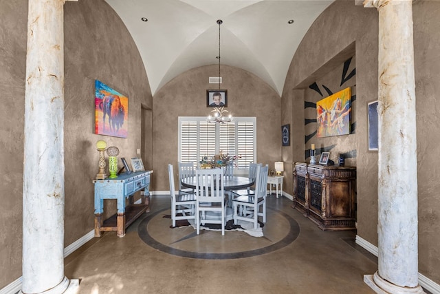 dining room with lofted ceiling, a chandelier, and decorative columns