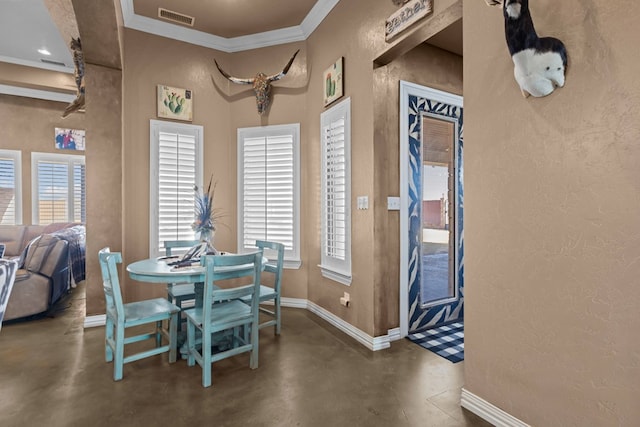 dining area featuring crown molding and a wealth of natural light