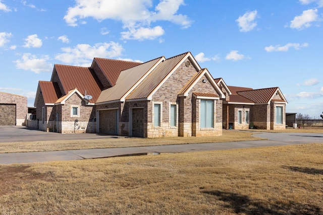 craftsman-style house with a garage and a front lawn