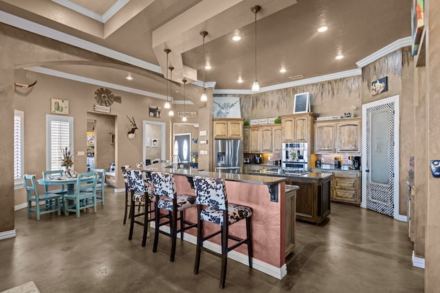 kitchen with a kitchen island with sink, a towering ceiling, stainless steel fridge, and a breakfast bar area