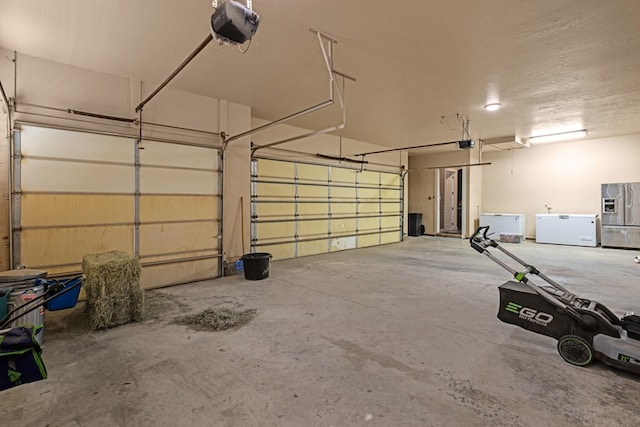 garage with fridge, a garage door opener, and stainless steel fridge with ice dispenser