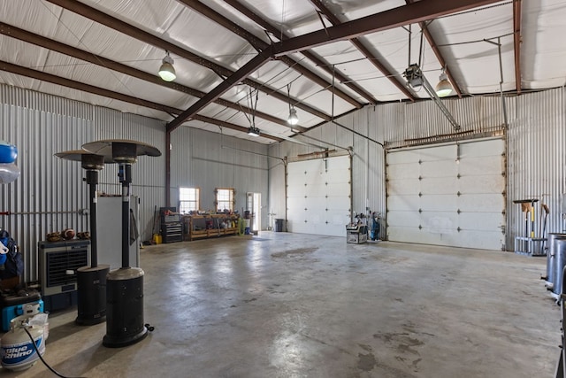 garage featuring heating unit and stainless steel refrigerator