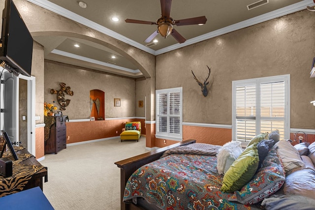 carpeted bedroom featuring ornamental molding and ceiling fan