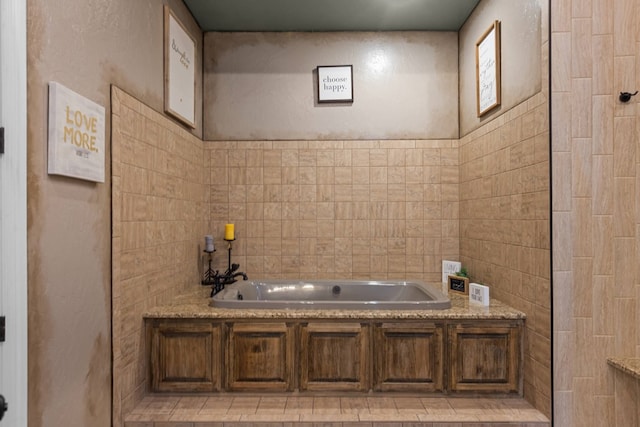 bathroom featuring a bathing tub and tile walls