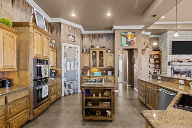 kitchen featuring pendant lighting, crown molding, stainless steel appliances, and a kitchen island