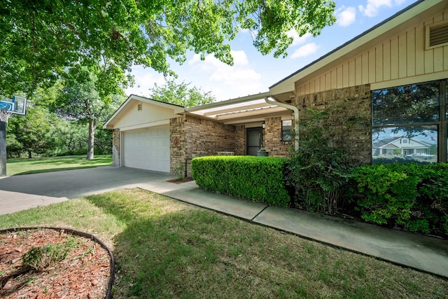 2100 Edgemere Rd, Big Spring, TX 79720 - view of front of house with concrete driveway, brick siding, a front lawn, and a garage