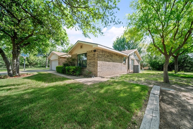 2100 Edgemere Rd, Big Spring, TX 79720 - view of home's exterior with brick siding, a lawn, and an attached garage