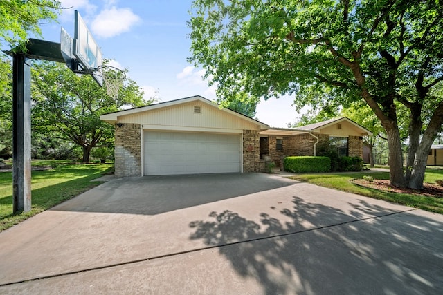 2100 Edgemere Rd, Big Spring, TX 79720 - view of front of property with driveway, an attached garage, brick siding, and a front lawn