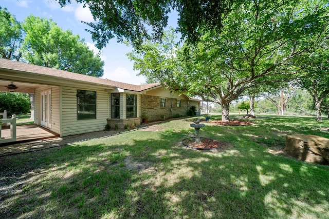 2100 Edgemere Rd, Big Spring, TX 79720 - view of green lawn featuring ceiling fan and a wooden deck