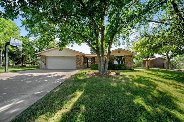 2100 Edgemere Rd, Big Spring, TX 79720 - view of front of property with concrete driveway, an attached garage, a front lawn, and brick siding