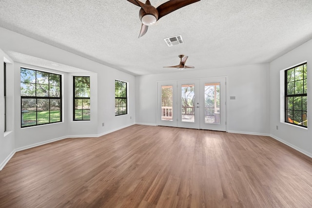 2100 Edgemere Rd, Big Spring, TX 79720 - spare room featuring a ceiling fan, wood finished floors, healthy amount of natural light, and a textured ceiling