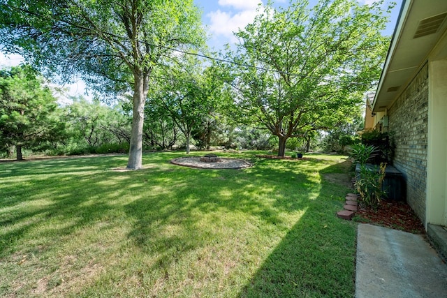 2100 Edgemere Rd, Big Spring, TX 79720 - view of green lawn with an outdoor fire pit
