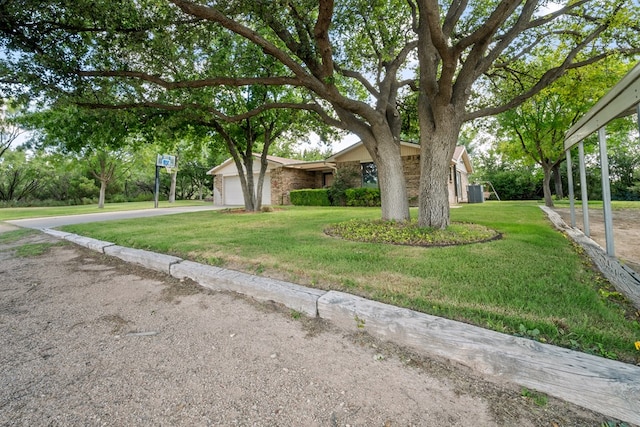 2100 Edgemere Rd, Big Spring, TX 79720 - mid-century inspired home featuring concrete driveway, a front yard, and an attached garage