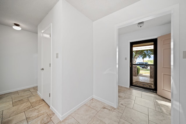 2100 Edgemere Rd, Big Spring, TX 79720 - entryway with baseboards and a textured ceiling