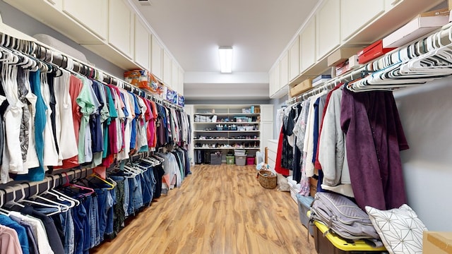 spacious closet with light hardwood / wood-style floors