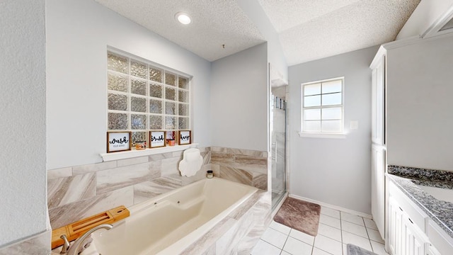 bathroom featuring tile patterned floors, vanity, independent shower and bath, and a textured ceiling