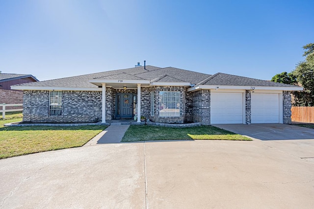 ranch-style house featuring a garage and a front lawn