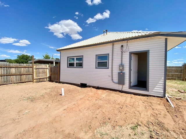 3007 S Anderson Rd, Big Spring, TX 79720 - rear view of property featuring a metal roof and a fenced backyard