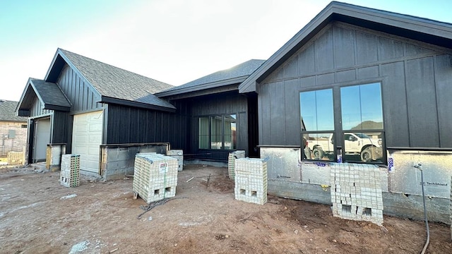 rear view of property with a garage