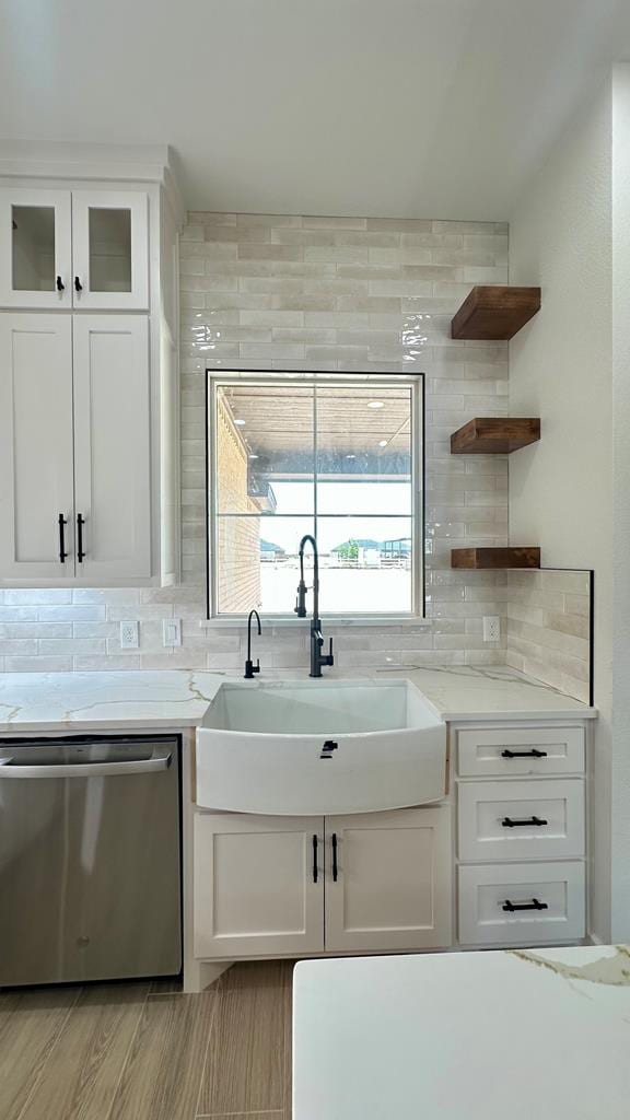 2118 S County Rd 1059, Midland, TX 79706 - kitchen featuring dishwasher, a sink, decorative backsplash, and white cabinetry