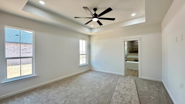 2118 S County Rd 1059, Midland, TX 79706 - unfurnished bedroom with a tray ceiling, carpet floors, baseboards, recessed lighting, and ceiling fan