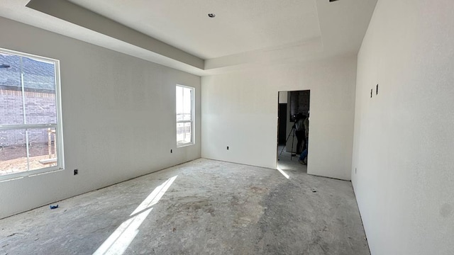 empty room featuring a tray ceiling