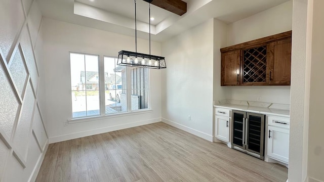 2118 S County Rd 1059, Midland, TX 79706 - unfurnished dining area with beverage cooler, a dry bar, light wood-style floors, baseboards, and recessed lighting