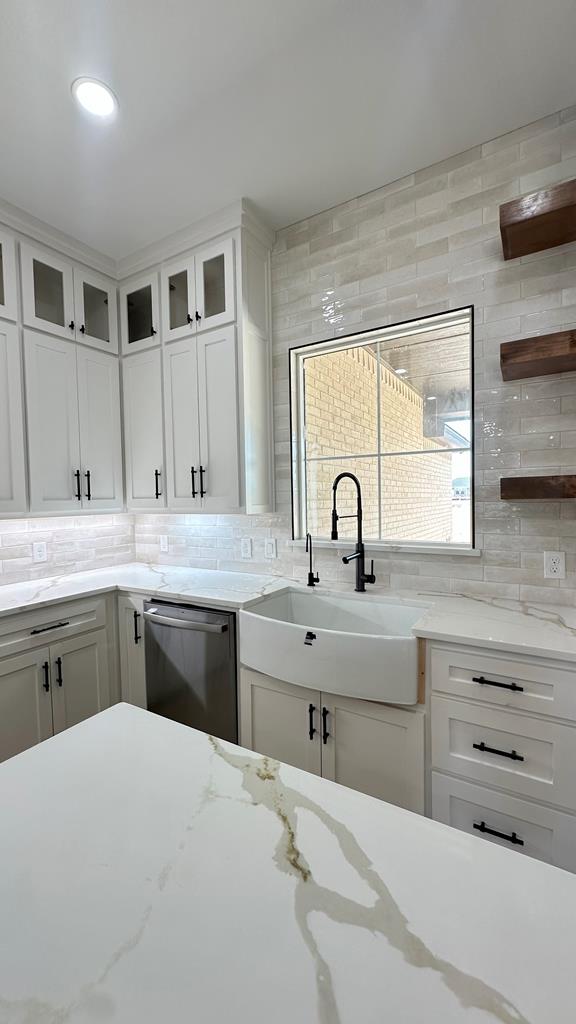 2118 S County Rd 1059, Midland, TX 79706 - kitchen with dishwasher, backsplash, a sink, and open shelves