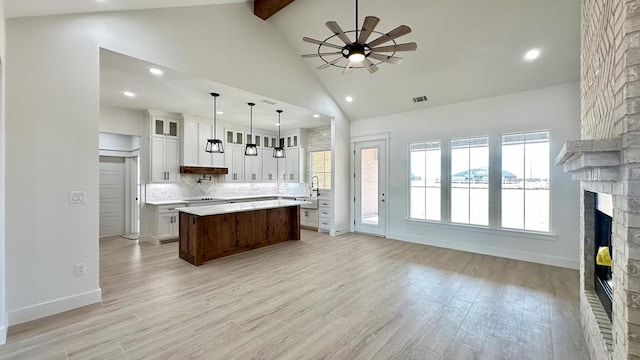 2118 S County Rd 1059, Midland, TX 79706 - kitchen featuring ceiling fan, light countertops, recessed lighting, a fireplace, and a center island
