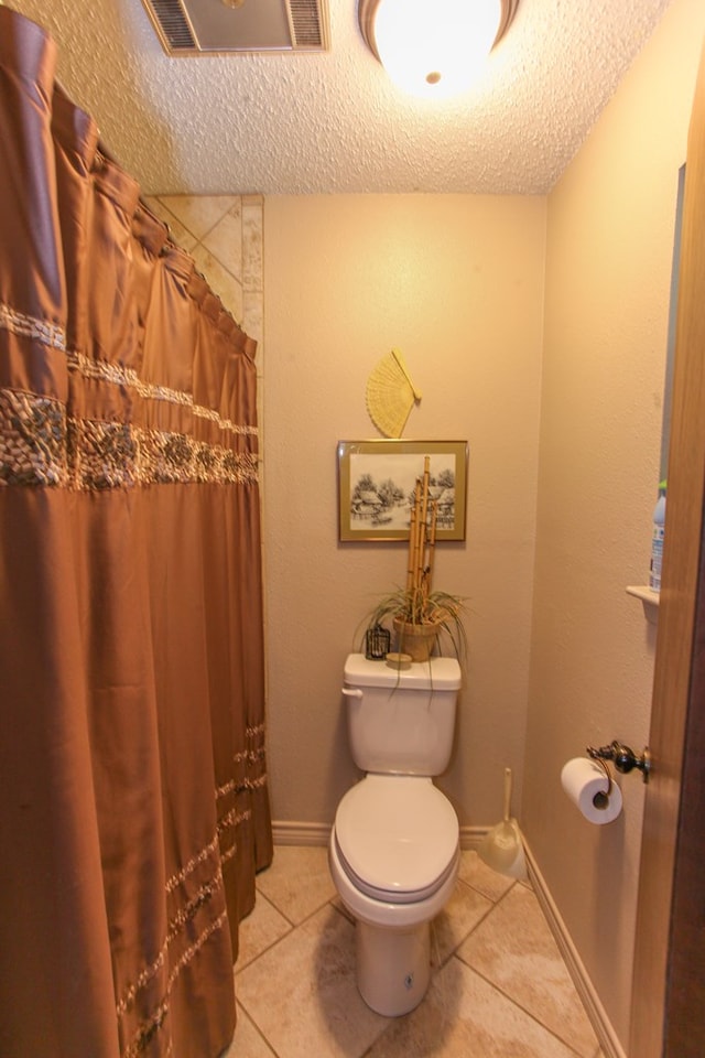 702 Capri Ct, Big Spring, TX 79720 - full bath featuring tile patterned floors, a textured ceiling, and a shower with curtain