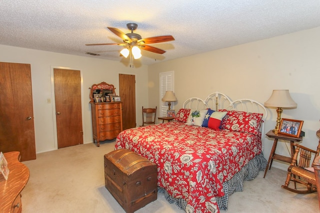 702 Capri Ct, Big Spring, TX 79720 - bedroom featuring light colored carpet, ceiling fan, and a textured ceiling