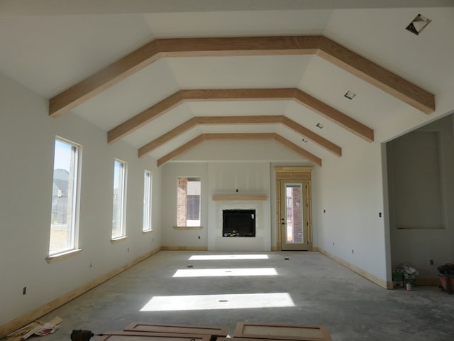 unfurnished living room with high vaulted ceiling