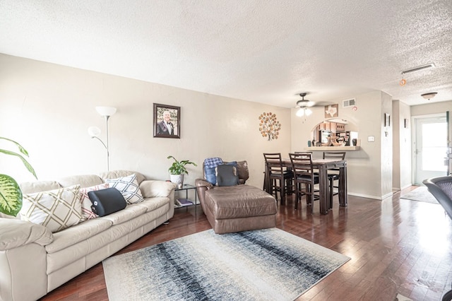 4700 Boulder Dr Unit 1604, Midland, TX 79707 - living room featuring a textured ceiling, ceiling fan, and dark wood-style flooring