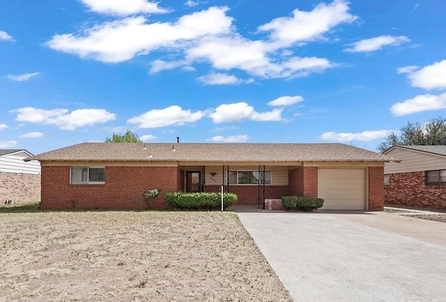 ranch-style house featuring brick siding, concrete driveway, and an attached garage