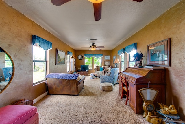 707 E County Rd 132, Midland, TX 79706 - carpeted living area featuring a ceiling fan and a textured wall