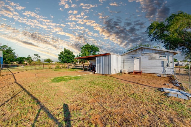 707 E County Rd 132, Midland, TX 79706 - yard at dusk with an outdoor structure and a carport